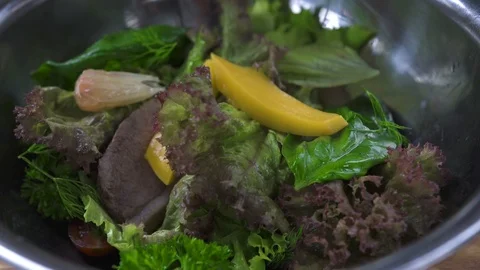 Cooking salad close up. Chef cook preparing vegetable salad with meat and citrus Stock Footage 104493410