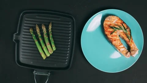Cooking salmon on grill pan with the addition of asparagus,sauce hollandaise Stock Footage 130575400