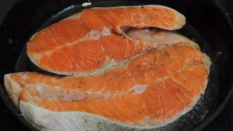 Cooking salmon in a pan. Stock Footage 130531395