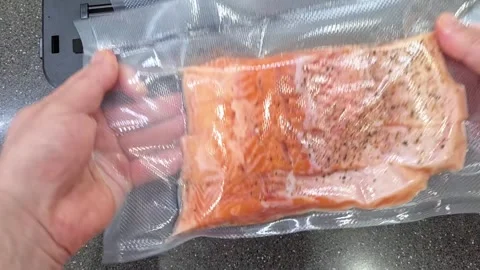 Cooking salmon using vacuum sealing method at home Stock Footage 335644744