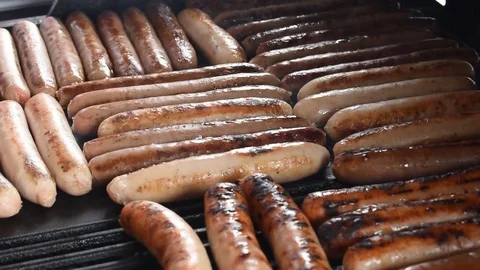 Cooking Sausages on a barbeque Stock Footage 76561438