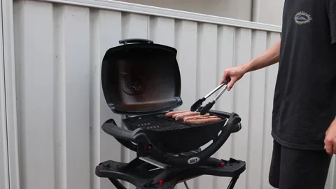 Cooking sausages on the barbeque Stock Footage 235581544