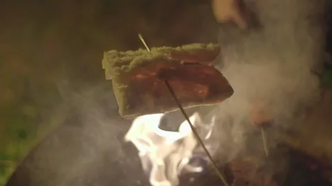 Cooking sausages at camp fire Stock Footage 141079729