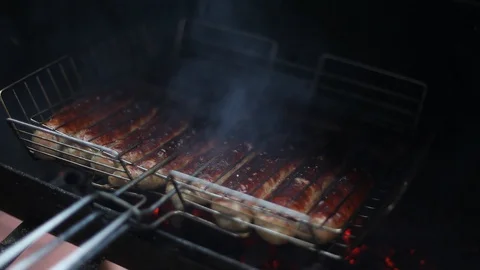 Cooking sausages in the grill. Stock Footage 129851568