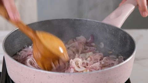 Cooking, sauteed onions in kitchen Stock Footage 205096832