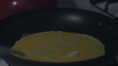 Cooking scrambled eggs on a non stick pan with rubber spatula in slow motion. Stock Footage 93630675