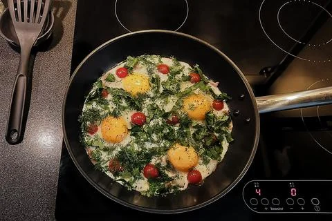 Cooking scrambled eggs. Stock Photos