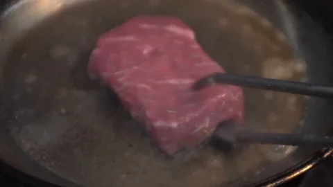 Cooking a Seared Ribeye Steak Stock Footage 127878028