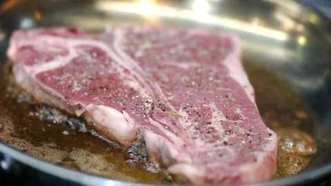 Cooking a Seared T bone Steak Stock Footage 127878027