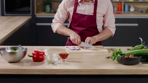 Cooking show hostscelebrity chef shows hot to cut onion, broadcast TV programme Stock Footage 130811798