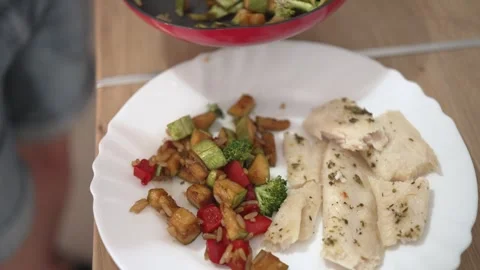 Cooking a simple dish with diced vegetables and creamy sauce on a plate during e Stock Footage 337106355