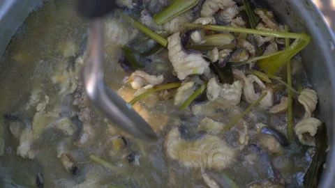 Cooking slice fish in boiling pot, soup fish delicious prepared, top view  Stock Footage 145840200