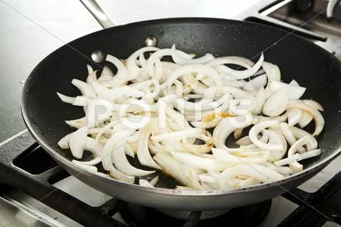 Cooking Sliced Onions in a Skillet Stock Photos