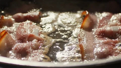 Cooking slices of bacon for breakfast. Bacon Frying in a Pan. 스톡 동영상 334641779