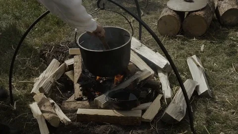 Cooking soup on a bonfire Stock Footage 94874436