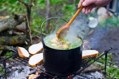 The cooking of soup on the fire Stock Photos