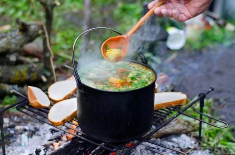 The cooking of soup on the fire Stock Photos