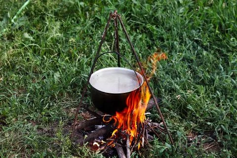 Cooking soup on a fire in a pot Foto stock