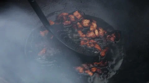 Cooking soup from lamb in cauldron. Man getting cracklings from fused mutton fat Stock-Footage 63662383