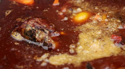 Cooking soup from lamb. The soup with mutton is preparing in a cauldron. Stock Footage 63662613