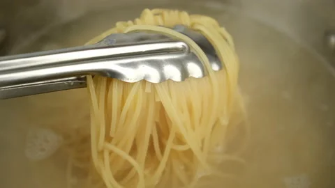 Cooking spaghetti in boiling water. Boiling pasta in pot, close up Stock Footage 236286935