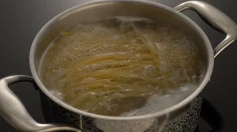 Cooking spaghetti in boiling water on electric stove Stock Footage 67990697