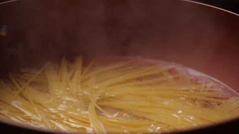 Cooking spaghetti in a pan in slow motion Stock Footage 134660256