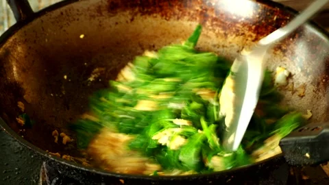 Cooking spinach with eggs in pan, in door  Chiangmai  Thailand. Stock Footage 264134877