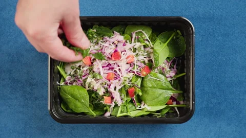 Cooking spinach salad close-up. Take away meal top view, Food delivery in closed Stock Footage 166574050