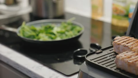 Cooking spinach on stovetop Stock Footage