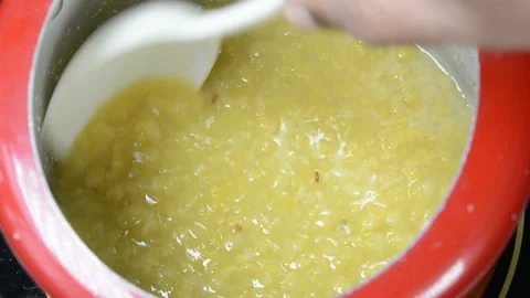 Cooking split pigeon peas in a pressure cooker Stock Footage 137532119