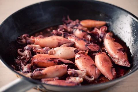 Cooking squid in a pan. High quality photo. Stock Photos