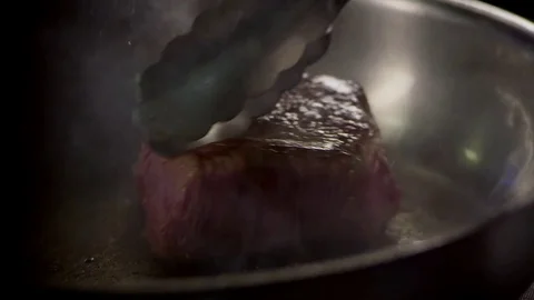 Cooking stake in slow motion Stock Footage 73605418