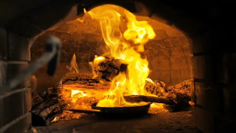 Cooking steak in a fire oven Stock Footage