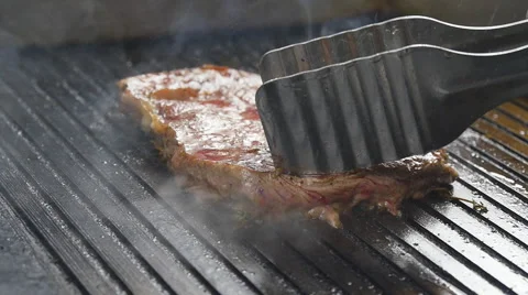Cooking steak the grill Stock Footage 65118393
