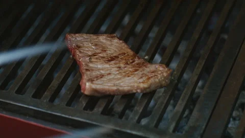 Cooking steak on a hot grill Stock Footage 200453088