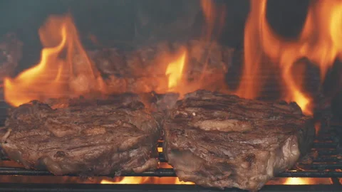 Cooking steaks on fire Stock Footage 198021573