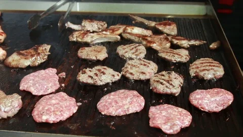 Cooking steaks on grill Stock Footage 107533934