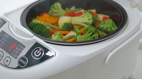 Cooking steamed vegetables in multicooker Stock Footage 74836593