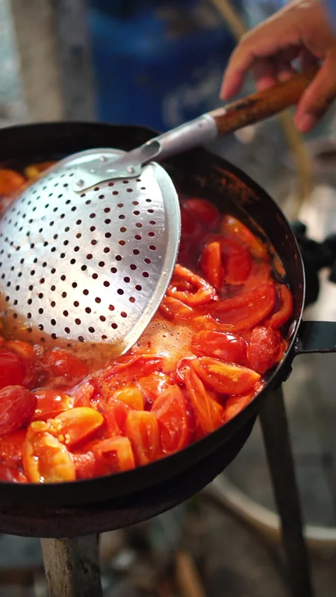 Cooking step: boiling fresh chopped tomatoes in hot water pan to prepare homemad Stock Footage 341673192