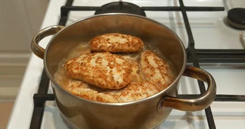 Cooking, stewing meat. Meat cutlets are stewed in saucepan. Meat patties Stock-Footage 317194780