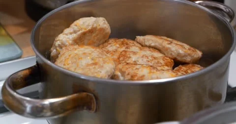 Cooking, stewing meat. Meat cutlets are stewed in saucepan after being fried Stock Footage 319130737