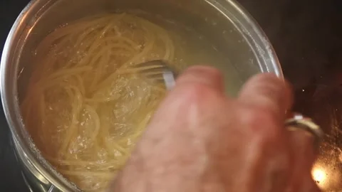 Cooking: Stirring pasta Stock Footage 278348035
