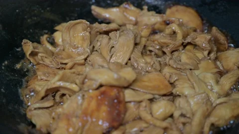 Cooking strips of chicken in a black pan 스톡 동영상 145439602