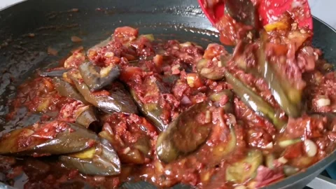 Cooking Strips of Corned Beef and Slices of Fried Eggplant in a Pan Stock Footage 241512330