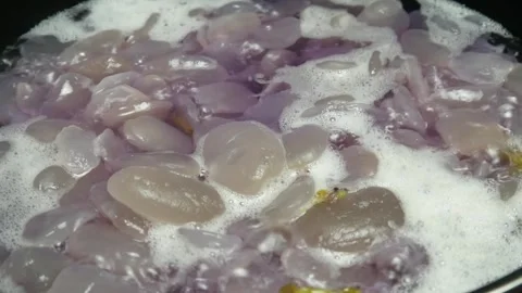 Cooking sugar palm fruit in a black pan Stock Footage 304722385