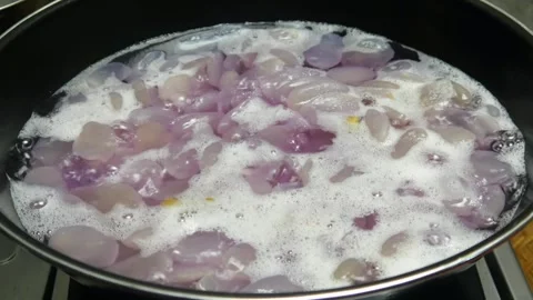 Cooking sugar palm fruit in a black pan Stock Footage 304722387