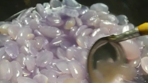 Cooking sugar palm fruit in a black pan Stock Footage 304722432