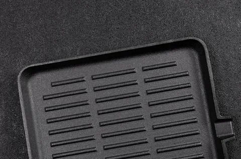 Cooking surface with ridges for grilling on a solid black background 库存照片