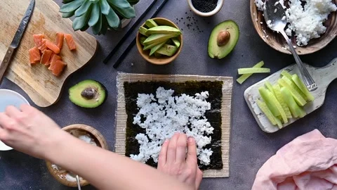 Cooking sushi process. Rice, fish fillets, cream cheese, avocado and cucumbers. Stock Footage 233032887
